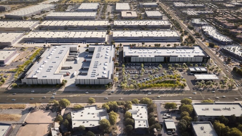 Aerial architectural rendering of Nexus Commerce Center showing multiple warehouse-style buildings with loading docks, parking lots, and surrounding road infrastructure in a desert urban setting