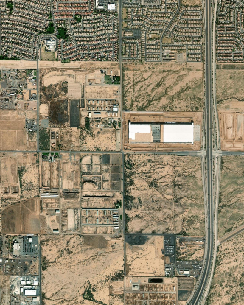 Satellite aerial vicinity map of Hawes Crossing showing all eight villages outlined in orange dashed boundaries, with Village 7 highlighted in green dashed lines at the southeast corner of Hawes Road and Elliot Road in Mesa
