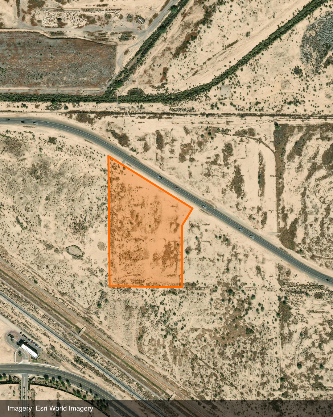 Esri World Imagery satellite aerial showing the approximately 10.8-acre parcel at 7237 E Pecos Road, Mesa, outlined in orange and bordered by a curving road to the northeast and desert scrubland.