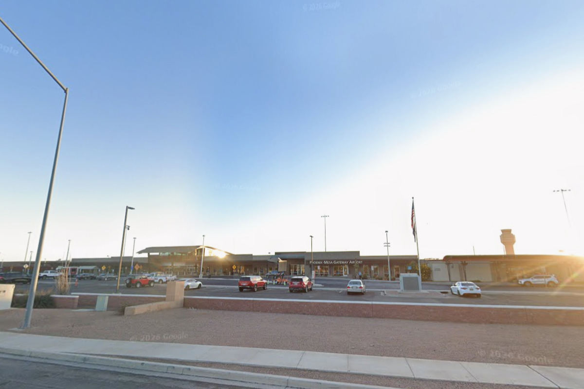 Phoenix-Mesa Gateway Airport terminal building at golden hour with the air traffic control tower visible on the right