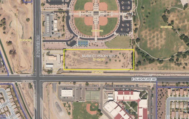 Satellite aerial view showing the vacant subject property outlined in yellow near the intersection of S Power Rd and E Guadalupe Rd, with a park and baseball fields to the north and a school campus to the south